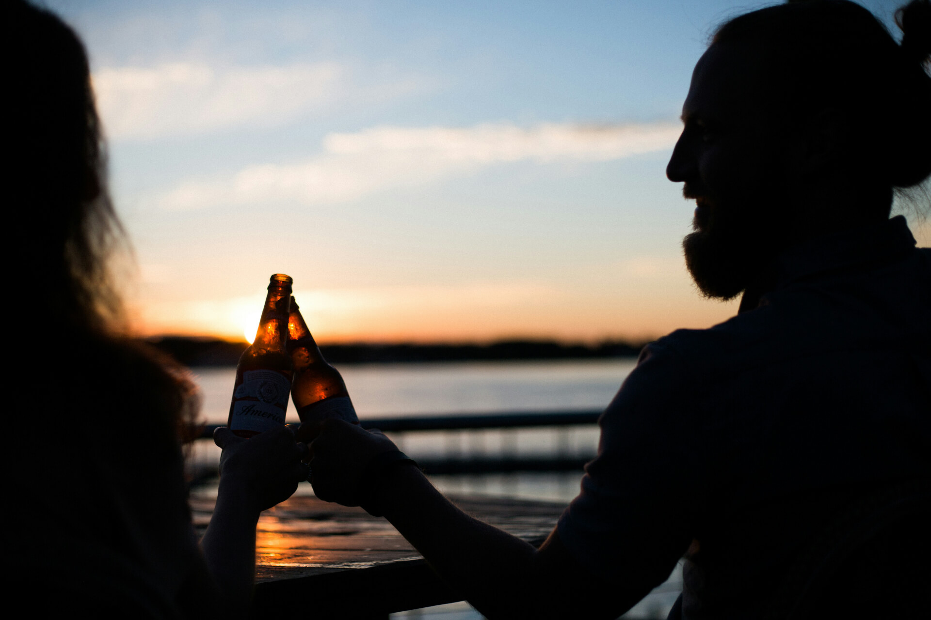 Enjoying drinks with a lakeside sunset view
