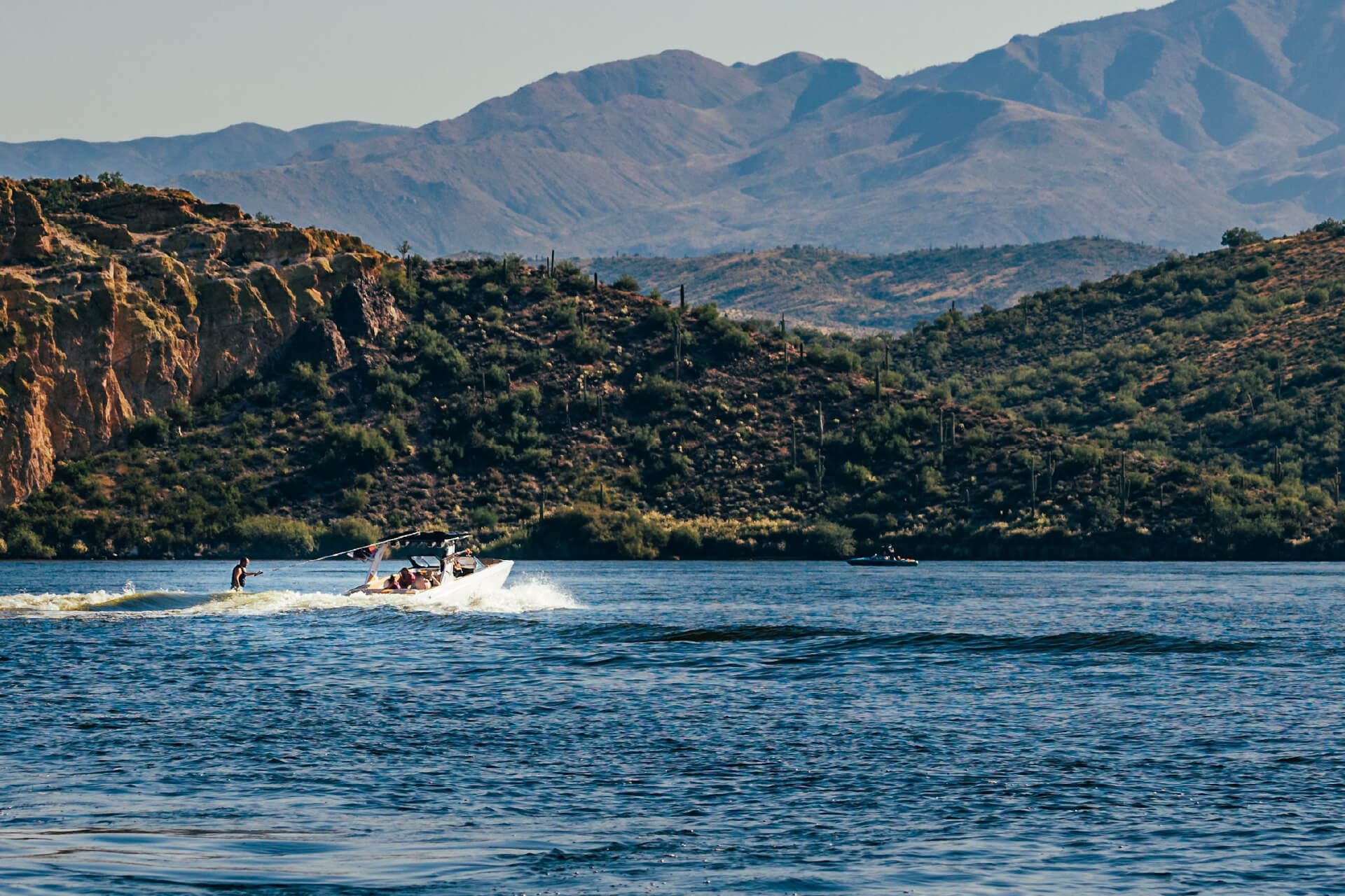Water sports at Saguaro Lake with mountain backdrop